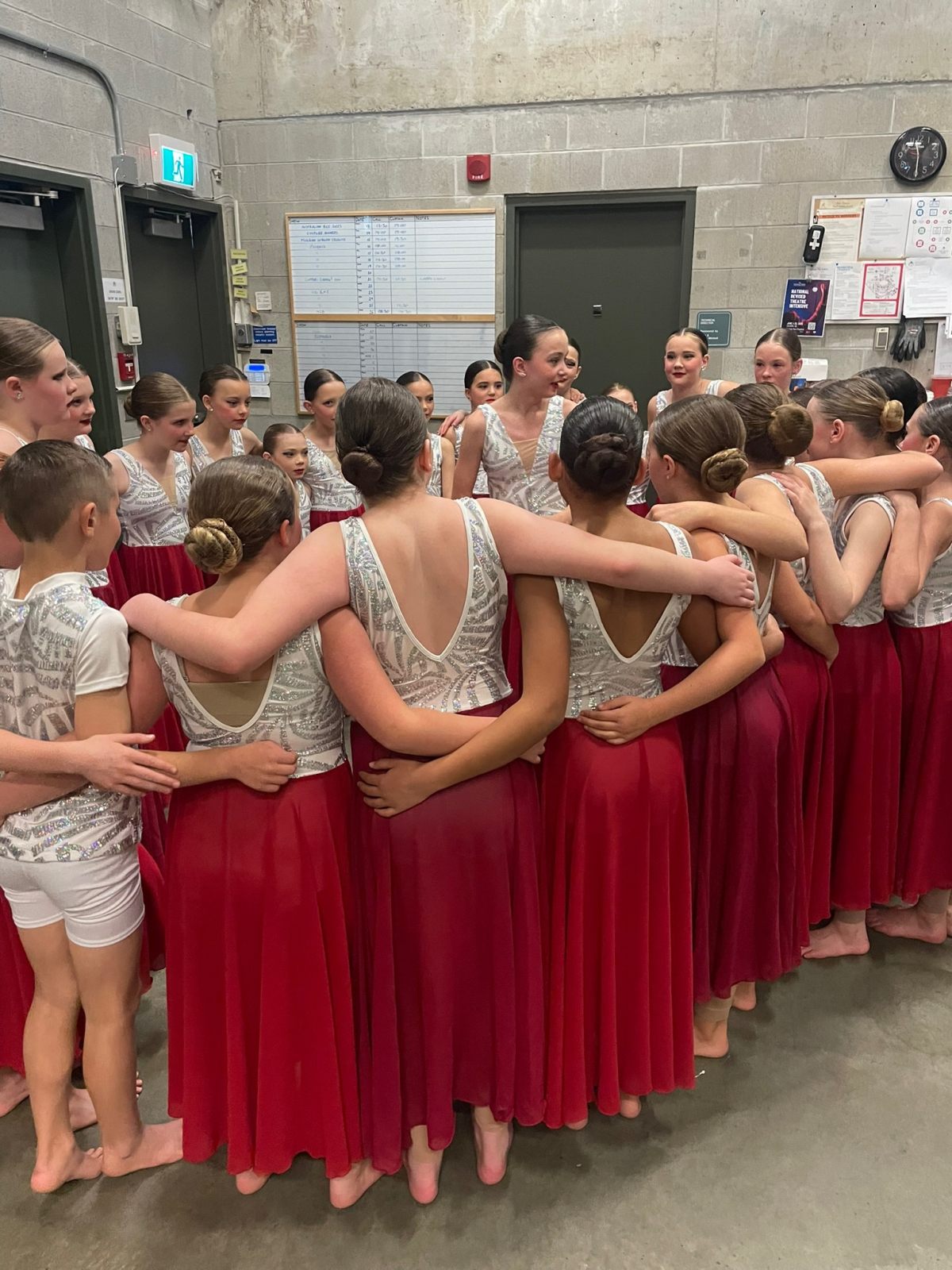 Phoenix dancers huddled together backstage